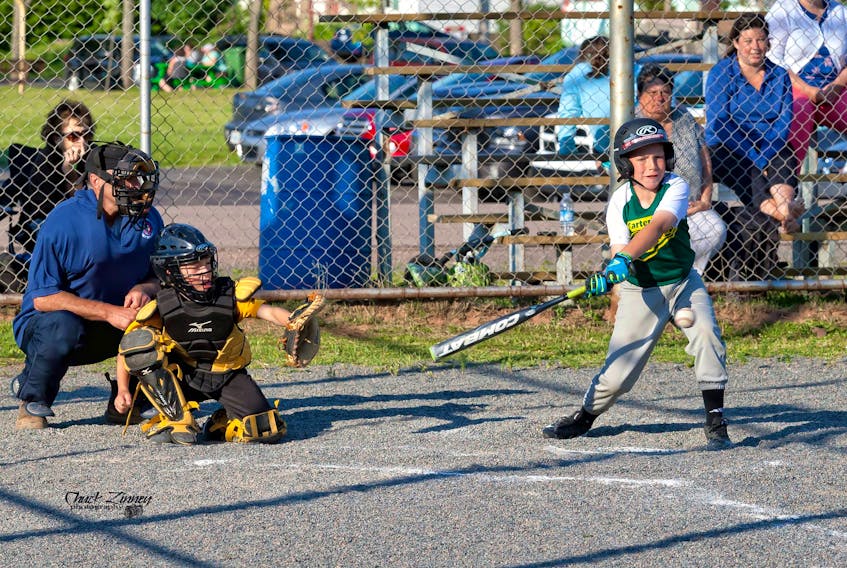 Will Allen of the Carter's Cresting Cubs swings at a pitch in little league action on Monday night against the Lions. The Lions won the game 11-6.
