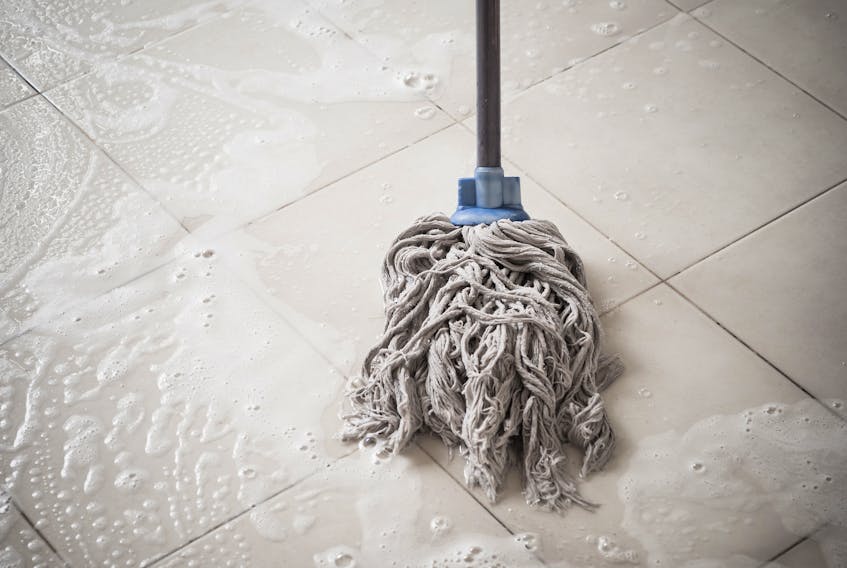 Stock image of a mop on a tile floor.