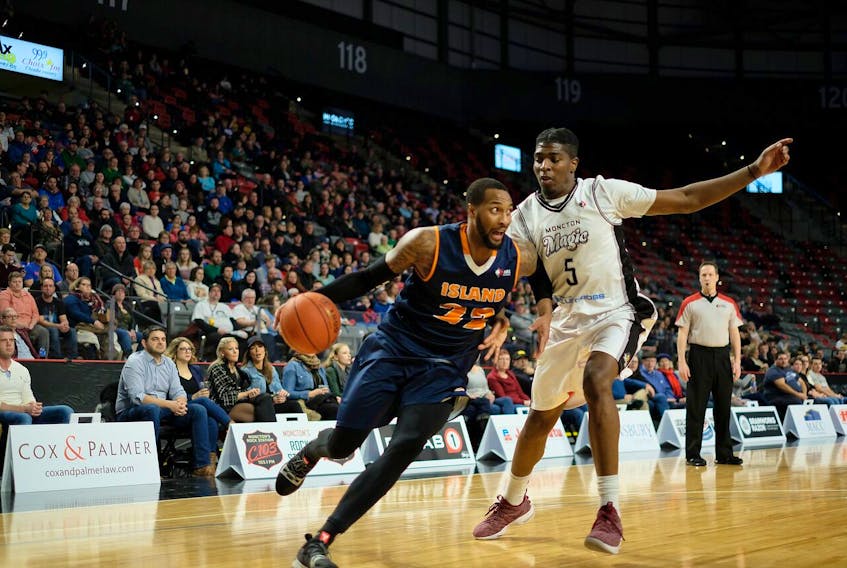The Island Storm's Sampson Carter, left, drives past Denzell Taylor of the Moncton Magic during National Basketball League of Canada play on Friday at the Avenir Centre. Mathieu Chiasson/Moncton Magic