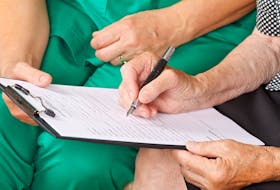 A patient signs a medical consent form.