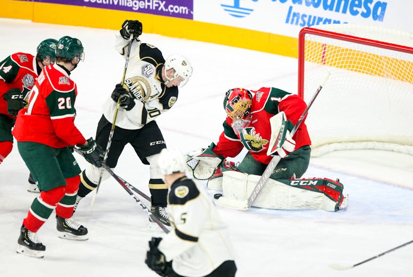 Halifax Mooseheads goaltender Alexis Gravel tries to reign in the loose puck after a shot from Charlottetown Islanders left-winger Brett Budgell late in the first period at the Scotiabank Centre Tuesday.