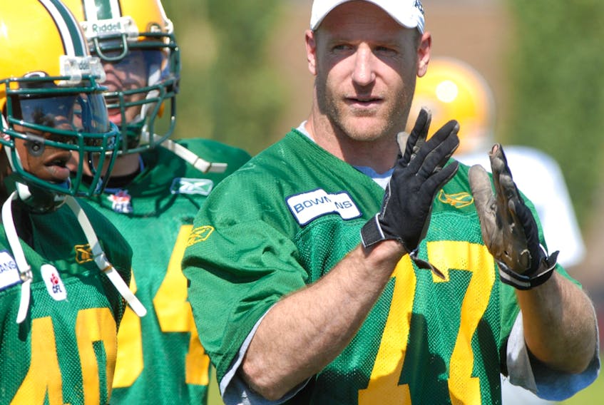 Former Edmonton Football Club linebacker A.J. Gass chats with some teammates at Clarke Park in this file photo from Aug. 12, 2006.