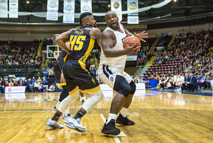 Glen Davis of the St. John's Edge looks for way to basket past Marvin Phillips (left) of the London Lightning during NBL Canada action at Mile One Centre Saturday night. Davis had 31 points as St. John's won 109-100. — St. John's Edge photo/Jeff Parsons