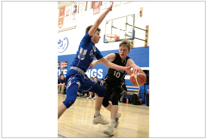 Jared Butt (left) of the Gonzaga Vikings tries to swipe the ball away from Caleb d’Entremont of the Holy Heart of Mary Highlanders during the final of the provincial 4A high school basketball championship Sunday at Gonzaga. The Highlanders won the game and the provincial 4A title.