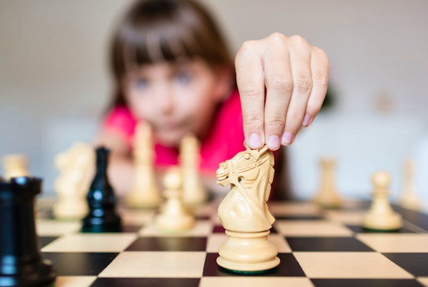 Girl playing chess.