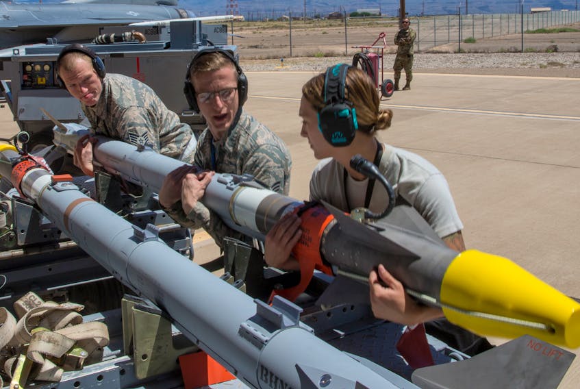 U.S. Air Force personnel prepare the AIM-9X Sidewinder missile for use during a live fire test at Holloman Air Force Base, New Mexico on April 23, 2019. (U.S. Air Force photo)