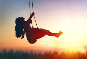 Girl on swing, sunset