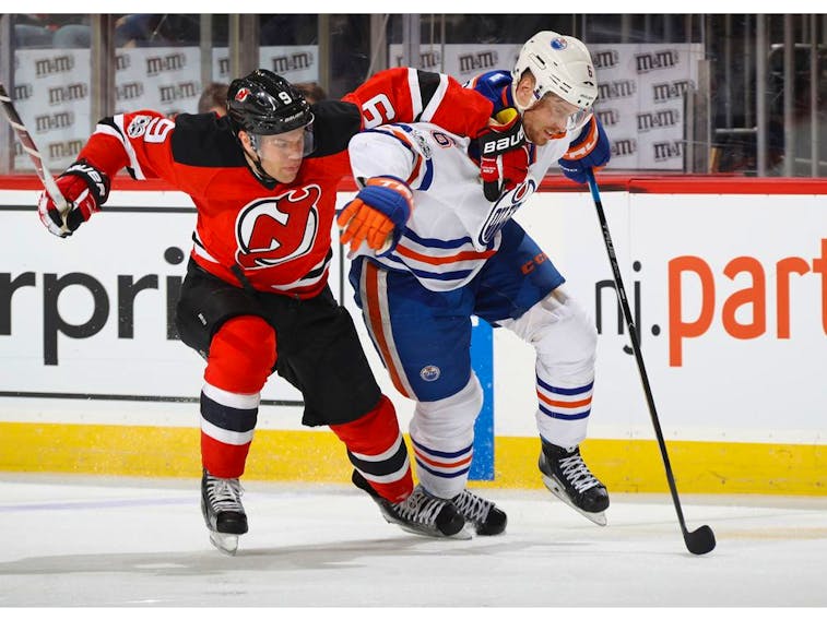Taylor Hall, formerly of the New Jersey Devils, and Edmonton Oilers defenceman Adam Larsson pursue the puck at the Prudential Center in this file photo from Jan. 7, 2017 in Newark, N.J.