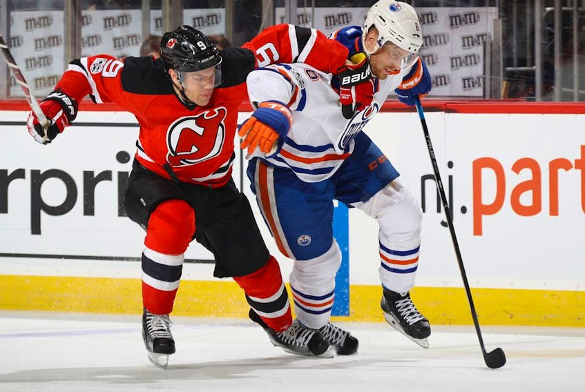 Taylor Hall, formerly of the New Jersey Devils, and Edmonton Oilers defenceman Adam Larsson pursue the puck at the Prudential Center in this file photo from Jan. 7, 2017 in Newark, N.J.
