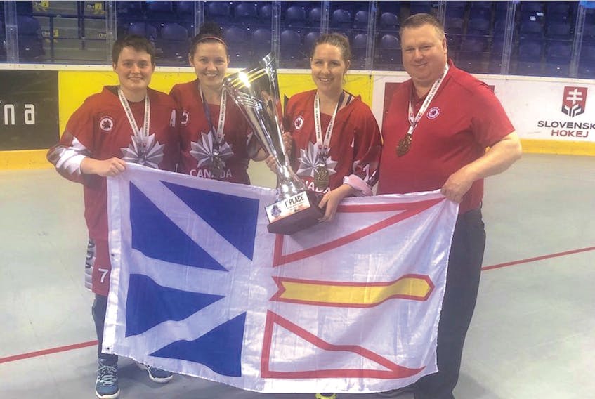 The four Newfoundlanders who were part of Canada’s gold medal-winning team at the 2019 world women’s ball hockey championship pose with the provincial flag and championship trophy after a 4-2 win over the United States Saturday in Košice, Slovakia. From left, are players Kristen Cooze of Kippens, April Drake of Long Cove and Dawn Tulk of Deer Lake and head coach Steve Power of St. John’s. — Twitter/@StevePowerNL