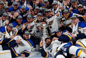 St. Louis Blues players pose for a team photo with the Stanley Cup after defeating the Boston Bruins in game seven of the 2019 Stanley Cup Final at TD Garden. 