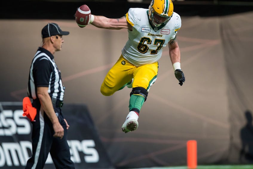 Edmonton Football Team right tackle Colin Kelly celebrates teammate Trevor Harris' touchdown against the B.C. Lions in Vancouver on July 11, 2019.