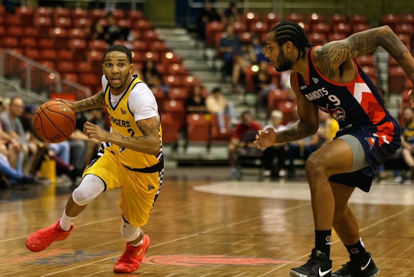 Edmonton Stingers guard Xavier Moon (2) battles Fraser Valley Bandits' Jelan Kendrick (9) in this file photo from Northlands Expo Centre in Edmonton on Aug. 1, 2019.