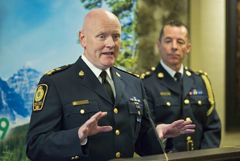 Canadian Association of Chiefs of Police president Adam Palmer, left, speaks while Calgary Police Chief Mark Neufeld listens during the association's annual conference at the Hyatt Regency hotel.