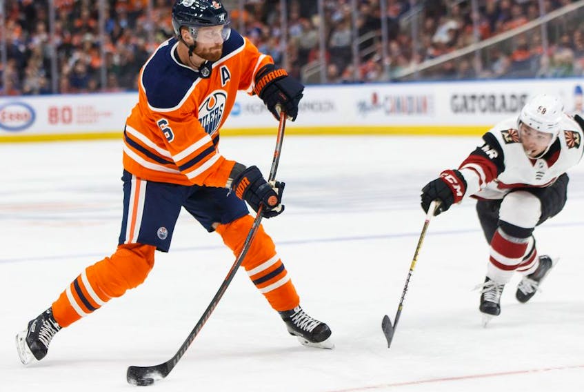Edmonton Oilers' Adam Larsson (6) shoots past Arizona Coyotes' Michael Bunting (58) during the second period of a NHL preseason game at Rogers Place in Edmonton, on Tuesday, Sept. 24, 2019. Photo by Ian Kucerak/Postmedia