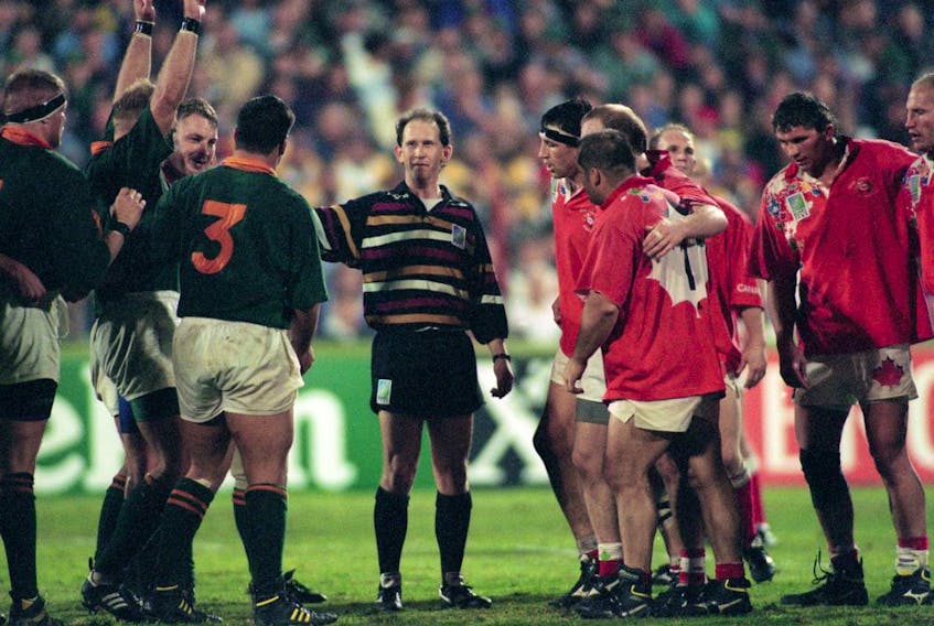 Referee David McHugh holds the two front rows apart during a Rugby World Cup match between Canada and South Africa in Port Elizabeth, 3rd June 1995. South Africa won 20-0.  ORG XMIT: 175309080 [PNG Merlin Archive]