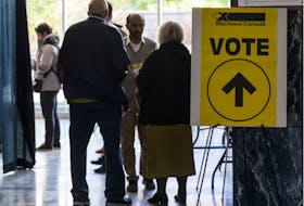 Voters enter the advance polling station at Ottawa City hall on Friday. 