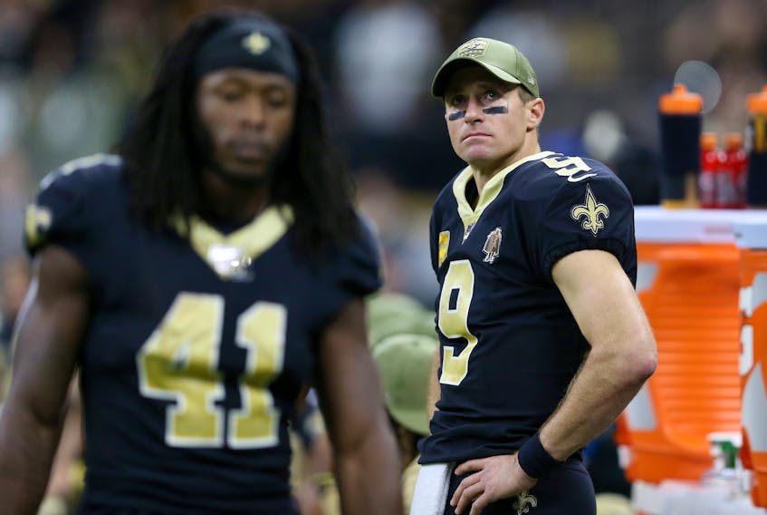 New Orleans Saints quarterback Drew Brees (9) looks on from the bench in the second half  against the Atlanta Falcons at the Mercedes-Benz Superdome. Saints running back Alvin Kamara (41) is at left. : Chuck Cook-USA TODAY Sports ORG 