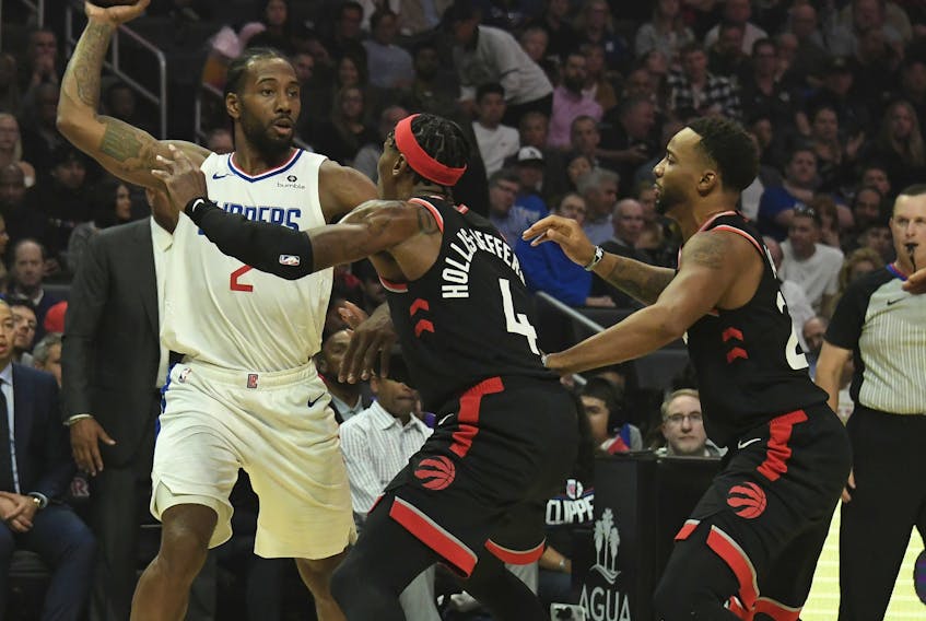 LA Clippers forward Kawhi Leonard (2) looks to pass the ball defended by Toronto Raptors forward Rondae Hollis-Jefferson (4) and guard Norman Powell (24) during the first half at Staples Center: Richard Mackson-USA TODAY Sports 