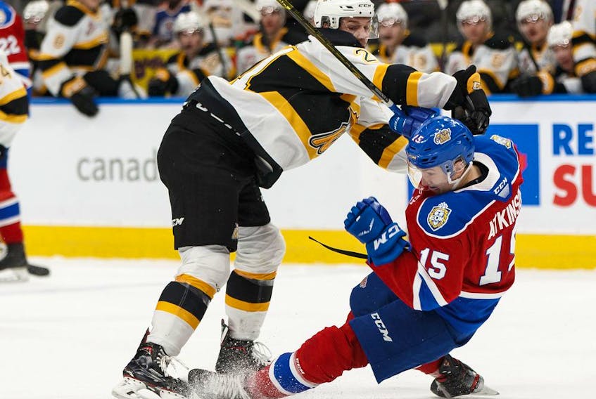 Edmonton Oil Kings' Scott Atkinson (15) is knocked down by Brandon Wheat Kings' Duncan Pierce (21) during the first period of a WHL hockey game at Rogers Place in Edmonton, on Sunday, Nov. 17, 2019. Photo by Ian Kucerak/Postmedia