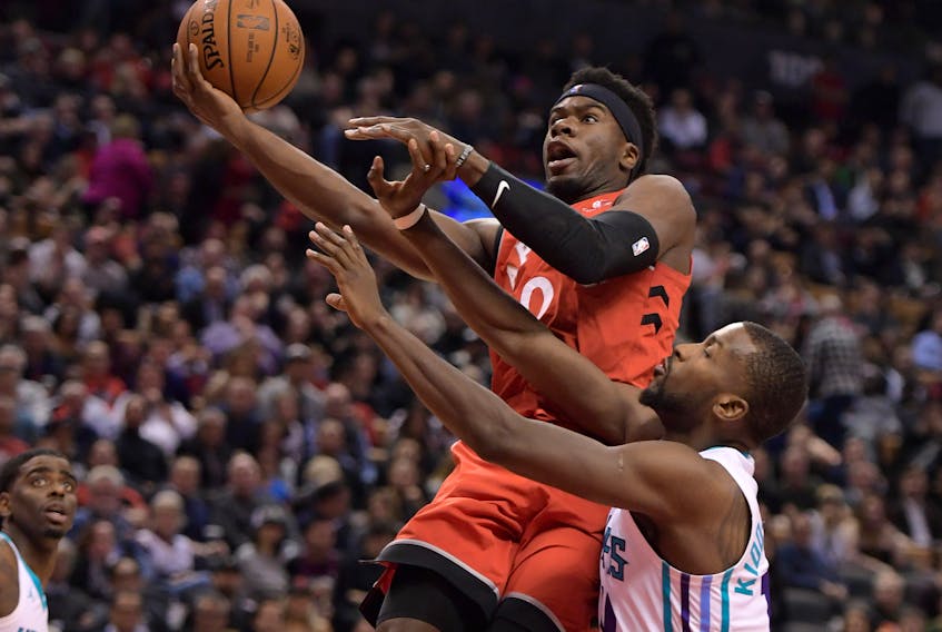 Toronto Raptors guard Terence Davis II  shoots for a lay up basket against Charlotte Hornets forward Michael Kidd-Gilchrist. Davis has been a force off the bench for the Raptors.  Credit: Dan Hamilton-USA TODAY Sports 