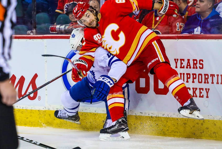 Calgary Flames right wing Michael Frolik (67) and Toronto Maple Leafs defenceman Morgan Rielly (44) battle for the puck during the first period at Scotiabank Saddledome. Mandatory Credit: Sergei Belski-USA TODAY Sports