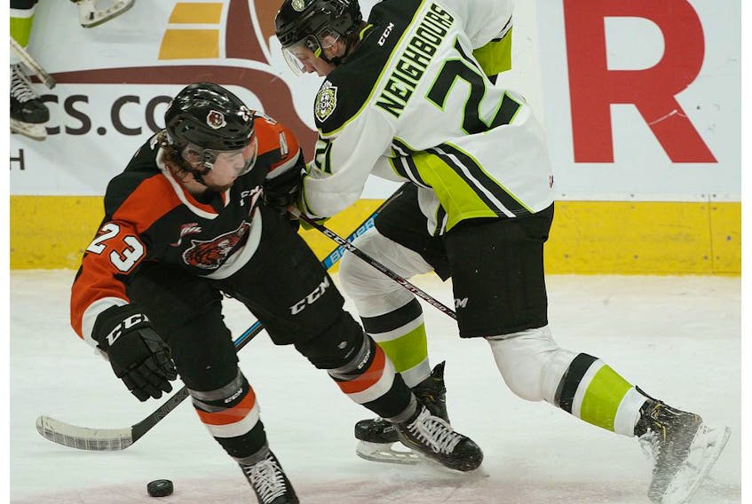 Edmonton Oil Kings forward Jake Neighbours (right) is checked by Medicine Hat Tigers Bryan Lockner at Rogers Place on Sunday, Jan. 19, 2020.
