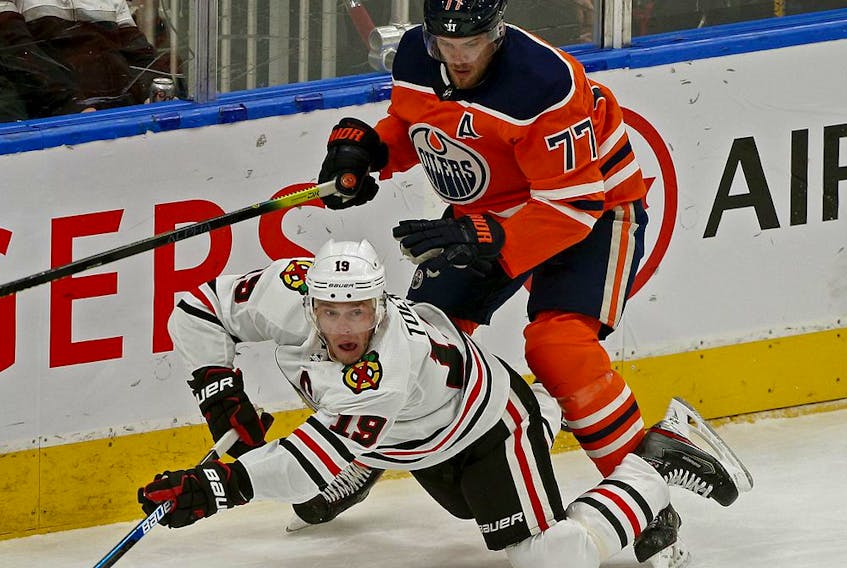 Chicago Black Hawks Jonathan Toews (left) is checked by Edmonton Oilers Oscar Klefbom during NHL hockey game action in Edmonton on Tuesday February 11, 2020. 