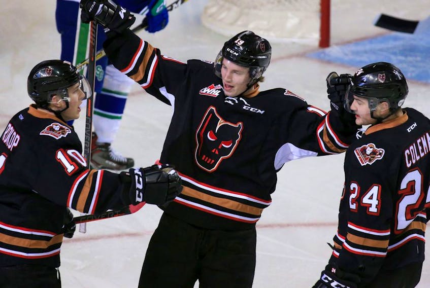 The Calgary Hitmen's Carson Focht, centre, celebrates with Josh Prokop and Luke Coleman after a goal on the Swift Currents during the TELUS BE BRAVE Anti-Bullying Game at the Scotiabank Saddledome on Wednesday February 27, 2019. Gavin Young/Postmedia ORG XMIT: POS1902271434350885