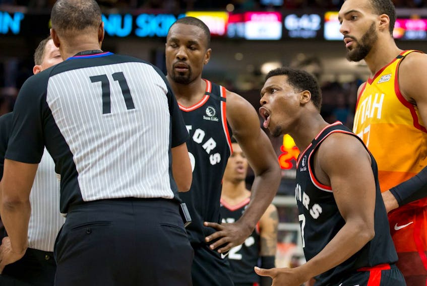 Toronto Raptors guard Kyle Lowry (second from right) argues with referee Rodney Mott (71) as Utah Jazz center Rudy Gobert (far right) looks on during the second half at Vivint Smart Home Arena. Mandatory Credit: Russell Isabella-USA TODAY  