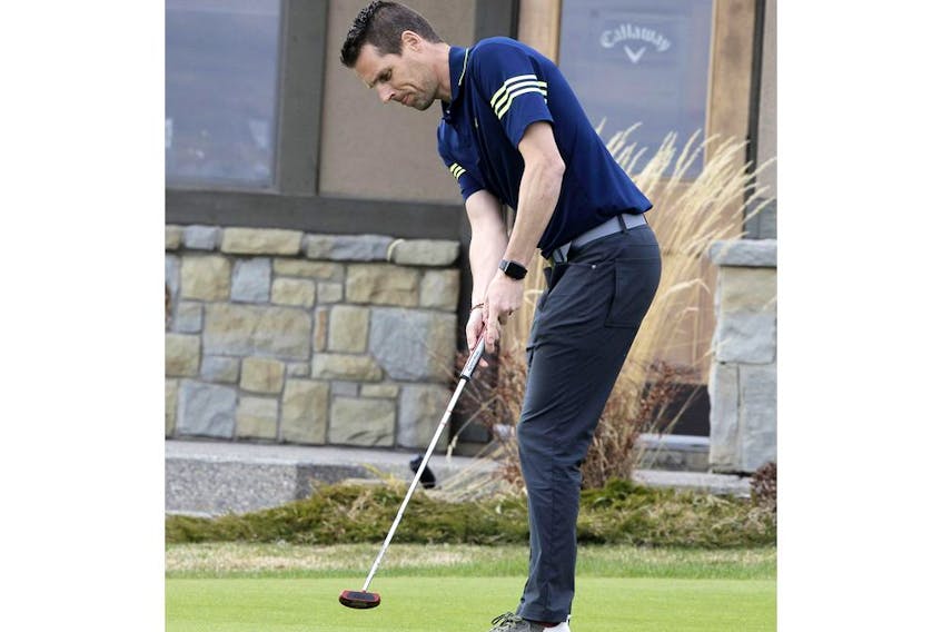Slade King, COO of Blue Devil Golf Club, hits the putting green following Premier Jason Kenney's announcement to gradually open Alberta's economy. Golf courses in Alberta will be allowed to open this weekend, following strict physical distancing measures, during the COVID-19 pandemic. Thursday, April 30, 2020. Brendan Miller/Postmedia