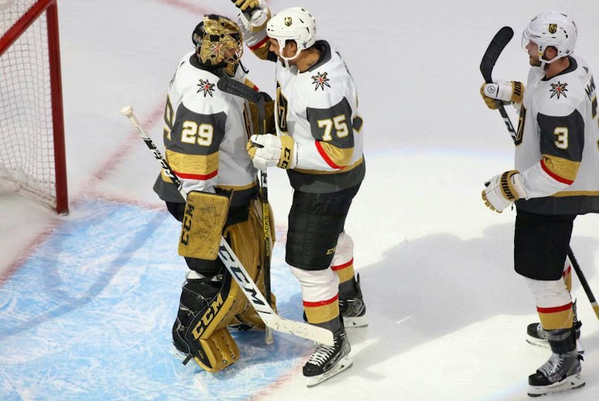 Vegas Golden Knights goaltender Marc-Andre Fleury (29) right wing Ryan Reaves (75) and defenseman Brayden McNabb (3) celebrate the 5-3 victory against the Vancouver Canucks  following Game 3 of the second round of the 2020 Stanley Cup Playoffs at Rogers Place on Aug. 30, 2020. 
