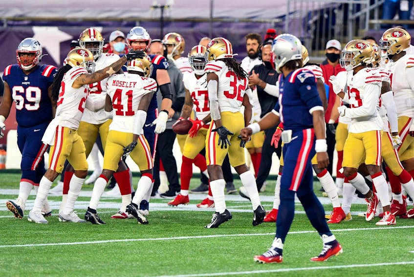 San Francisco 49ers cornerback Emmanuel Moseley (41) celebrates with teammates after a pick-six against New England Patriots quarterback Cam Newton (1) on Sunday at Gillette Stadium.