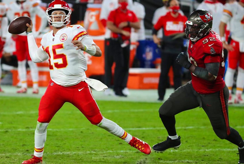 Chiefs quarterback Patrick Mahomes (left) makes a pass as Buccaneers defensive end William Gholston closes in during 
the first half in Tampa yesterday. Mahomes threw for 462 yards and three TDs in the 27-24 win over the Chiefs. 