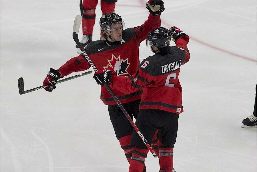 Canada's Jamie Drysdale (6) celebrates his goal against Russia with teammate Bowen Byram (4) during third period IIHF World Junior Hockey Championship pre-competition action on Wednesday, Dec. 23, 2020 in Edmonton.