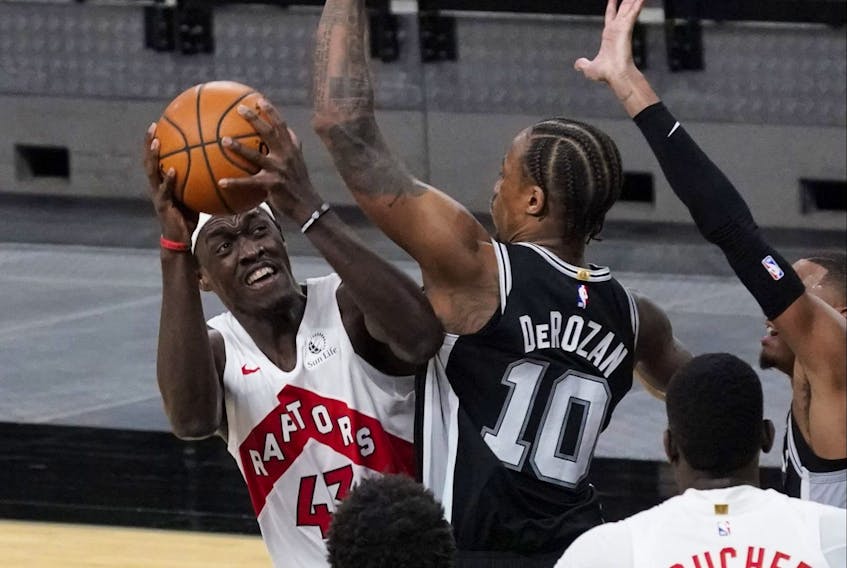 Toronto Raptors forward Pascal Siakam (43) shoots over San Antonio Spurs guard DeMar DeRozan on Saturday night. 
