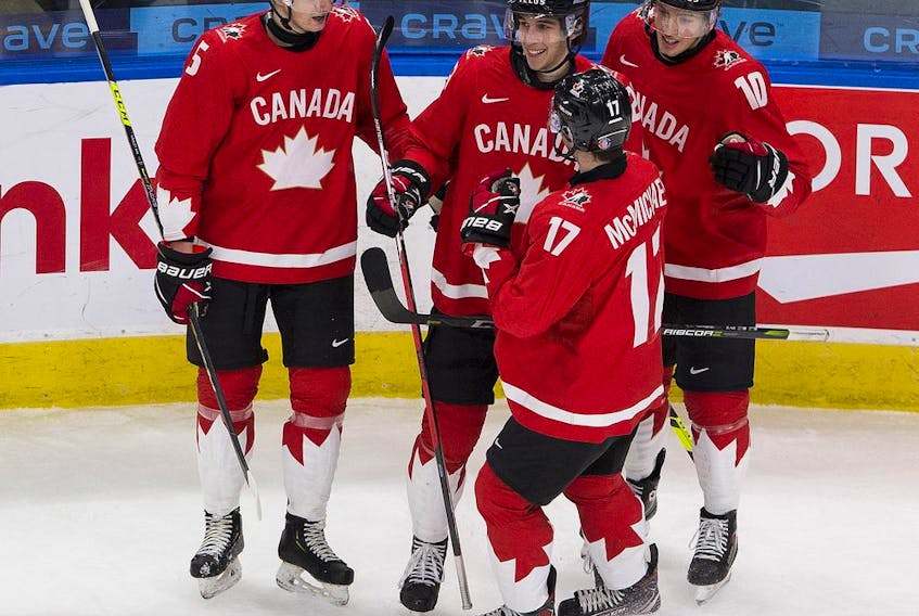 Canada's Dylan Cozens (22) celebrates his goal with teammates against Finland during first period IIHF World Junior Hockey Championship action on Thursday, Dec. 31, 2020 in Edmonton. 