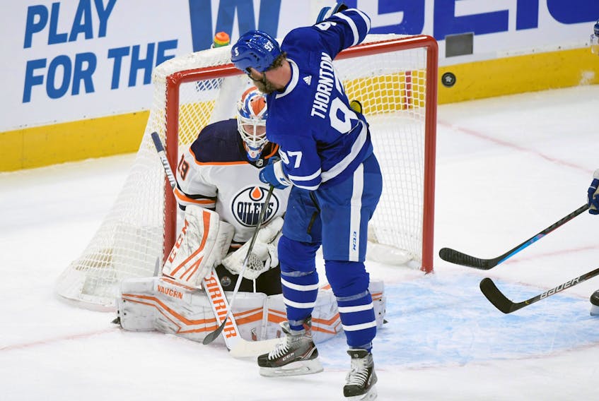 Toronto Maple Leafs forward Joe Thornton (97) deflects the puck and Edmonton Oilers goalie Mikko Koskinen (19) makes a save in the first period at Scotiabank Arena. 