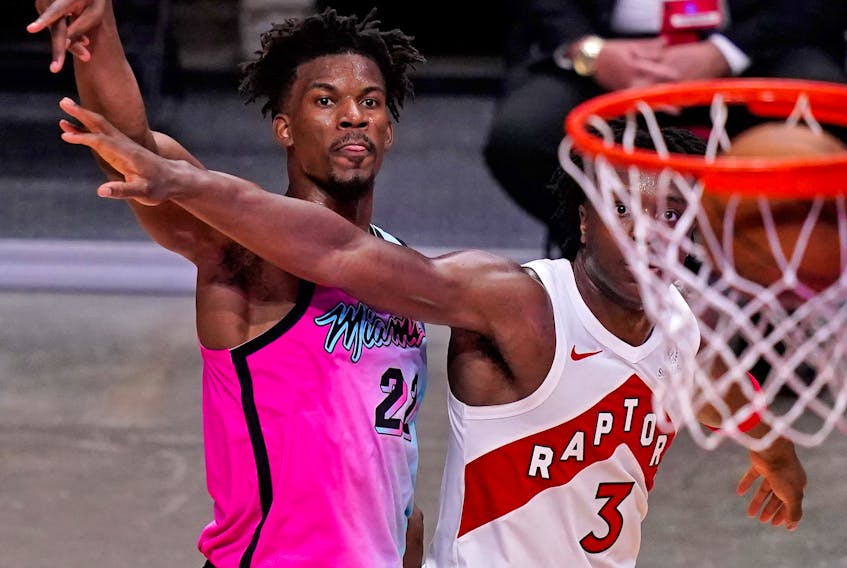 Heat forward Jimmy Butler (22) watches the ball into the net after shooting over Toronto Raptors forward OG Anunoby during the Heat's win on Wednesday. 
