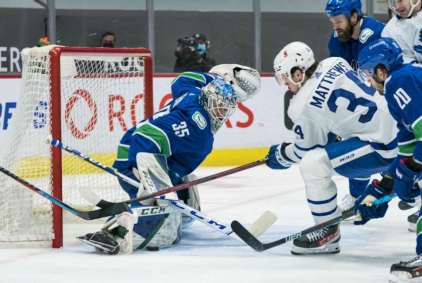 Canucks goalie Thatcher Demko makes a save on Maple Leafs forward  Auston Matthews (34) in the third period at Rogers Arena.