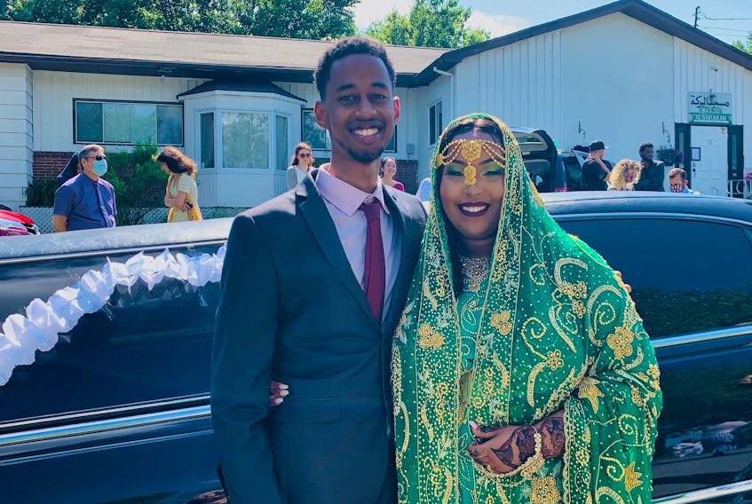 Amina Abawajy (right) and Hamza Youssouf in front of their limo after their wedding ceremony at Al Baraka Masjid. The couple celebrated their wedding on Saturday, June 20.