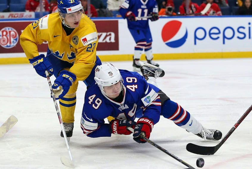 Max Jones #49 of United States tries to control the puck as Jacob Moverare #27 of Sweden defends in the second period during the IIHF World Junior Championship at KeyBank Center on January 4, 2018 in Buffalo, New York. 
