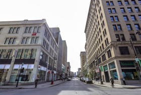 The corner of Peel and Ste-Catherine Sts. is seen in the middle of a weekday in March 2020. 