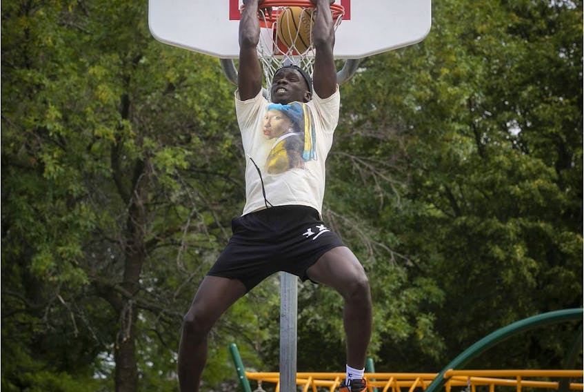 Basketball player Karim Mané dunks at a court near his home in St-Hubert on July 23, 2020. 