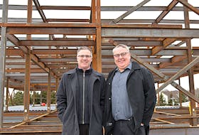 Kenny MacDougall, left, headmaster at the Mount Academy, and Paul Jenkins, The Mount's owner, stand on top of the roof at the existing Mount caring facility a few metres from the new, 70,000 square-foot expansion under construction behind them.  ©THE GUARDIAN
