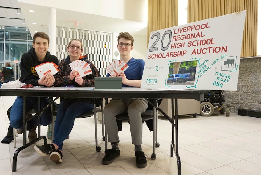 Liverpool Regional High School students Ben Hatt, Chantelle Bulley-Langille and Dylan Rhyno sell tickets for the school’s 20th scholarship auction at Queens Place Emera Centre Feb. 24.