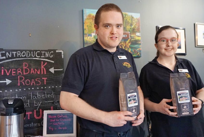 Colby Oickle and Mackenzie Colp display the Riverbank General Store & Café’s recently launched custom labelled Just Us! coffee blend April 19.
