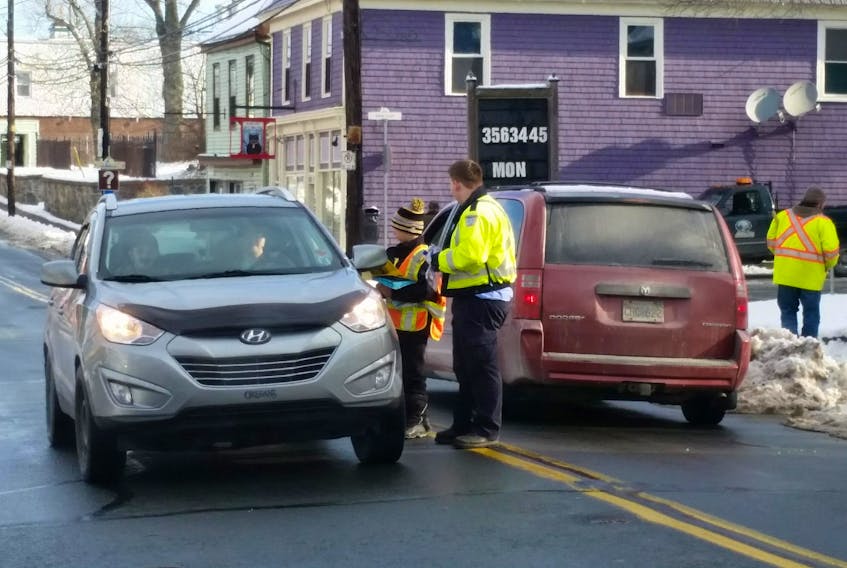 A new litter abatement group holds a traffic stop outside of Guy’s Frenchys on Main Street Jan. 19. The group aims to raise awareness and educate the public.