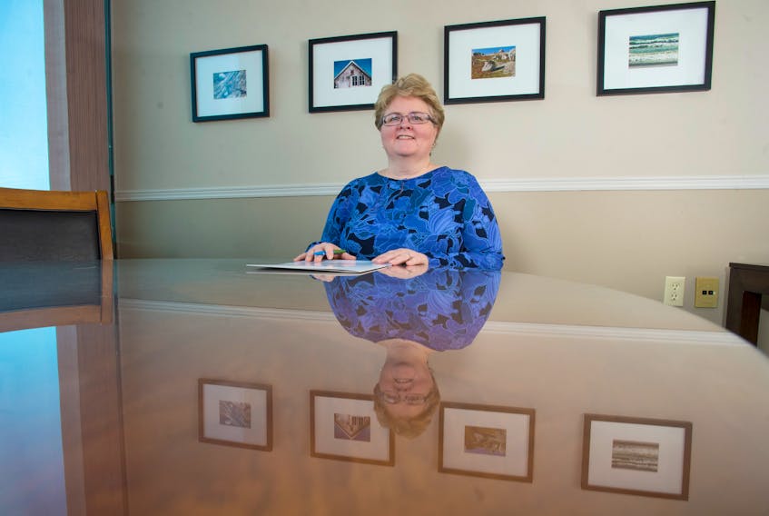 Myrna Gillis, co-founder and president of Aqualitas, sits in the company’s Bedford office. The company’s facility in Queens County, located on the old Bowater site, recently got the green light to produce medical marijuana.