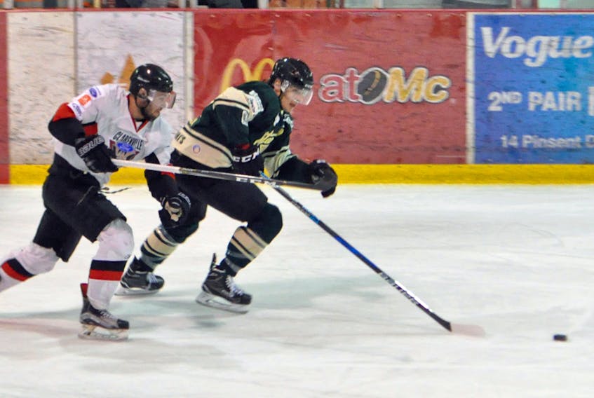 Cataracts’ Andrew Brennan and Caribous’ Kevin Reid race for the puck during Sunday Central West Senior Hockey action.